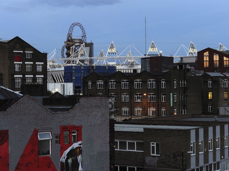 The Olympic stadium is seen beyond the rooftops of Hackney Wick