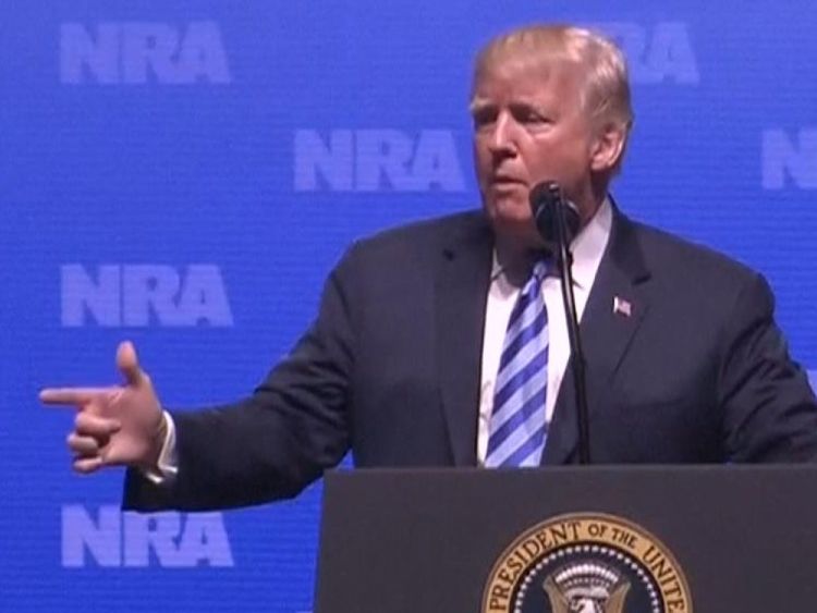 Donald Trump makes a gun gesture and shouts &#39;boom&#39; as he talks about how guns could have stopped the Paris attack