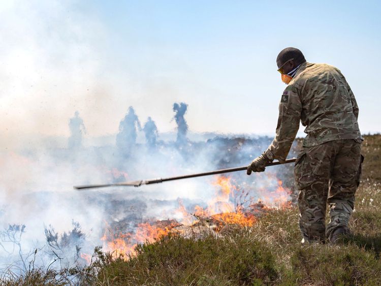 Soldiers from The Highlanders, 4th Battalion, Royal Regiment of Scotland work to bring the fire under control on Saddleworth Moor