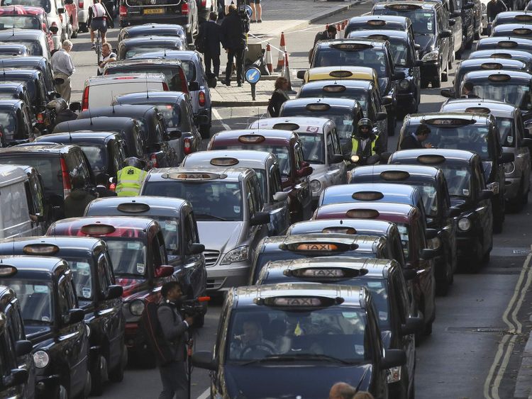London black cabs clog up Whitehall during a protest against Uber and other ride-sharing services