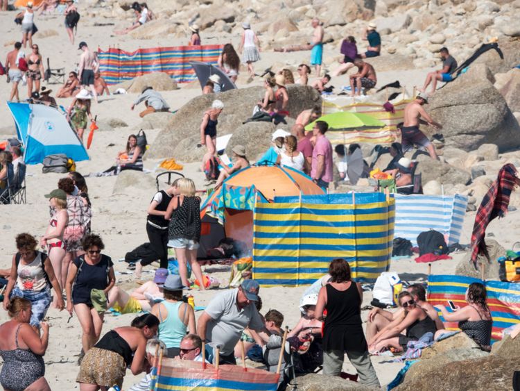 People enjoy the fine weather as they spend time on the beach at Sennen Cove near Penzance on June 28, 2018 in Cornwall, England. Parts of the UK are continuing to experience heatwave weather and record breaking temperatures
