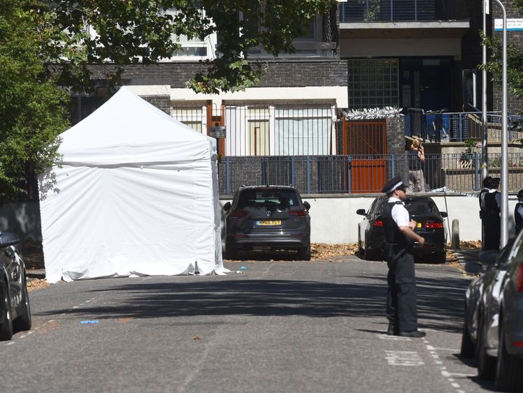 Police guard a forensic tent on Warham Street 