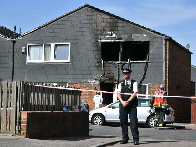 A police officer at the scene of a house fire on Adolphus Street, Deptford
