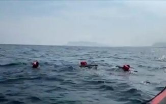 Desperate migrants jump overboard from charity boat off Italy