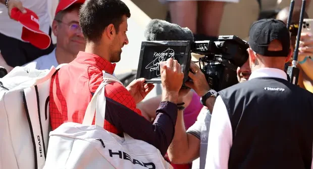 Novak Djokovic wrote on the camera lens: 'Kosovo is the heart of Serbia. Stop the violence'. Photograph: Jean Catuffe/Getty Images